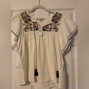 *NEVER WORN WITH TAGS* Embroidered peasant top with tassels.  Size L.